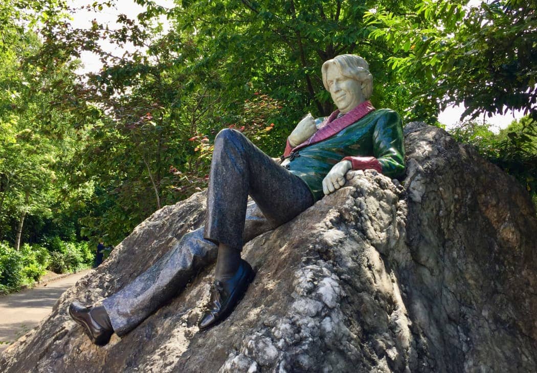 Man cast iron statue on rock