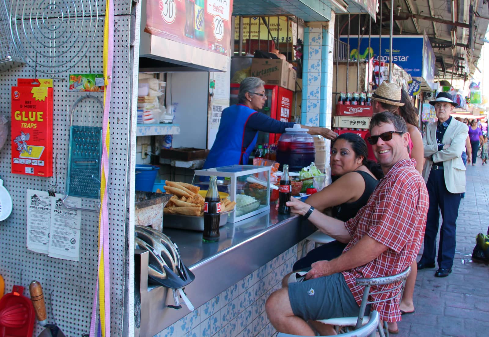 Man enjoying bottle of cola at street food vendor