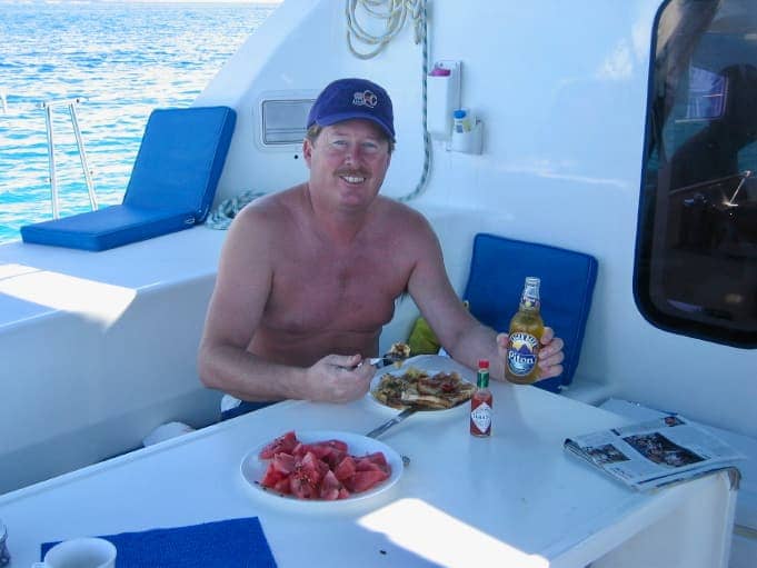 Man enjoying meal on sailing boat