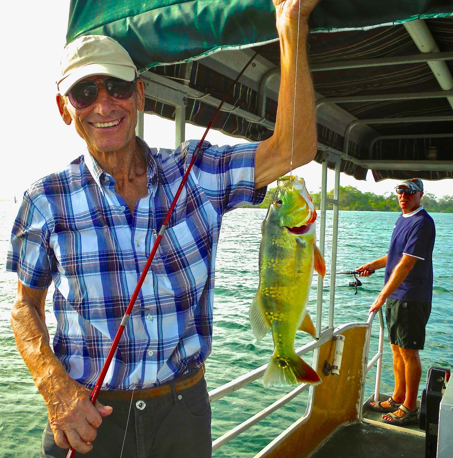 Man holding colourful fish on fishing line