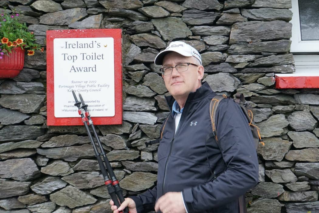 Man pointing to top toilet award in Ireland