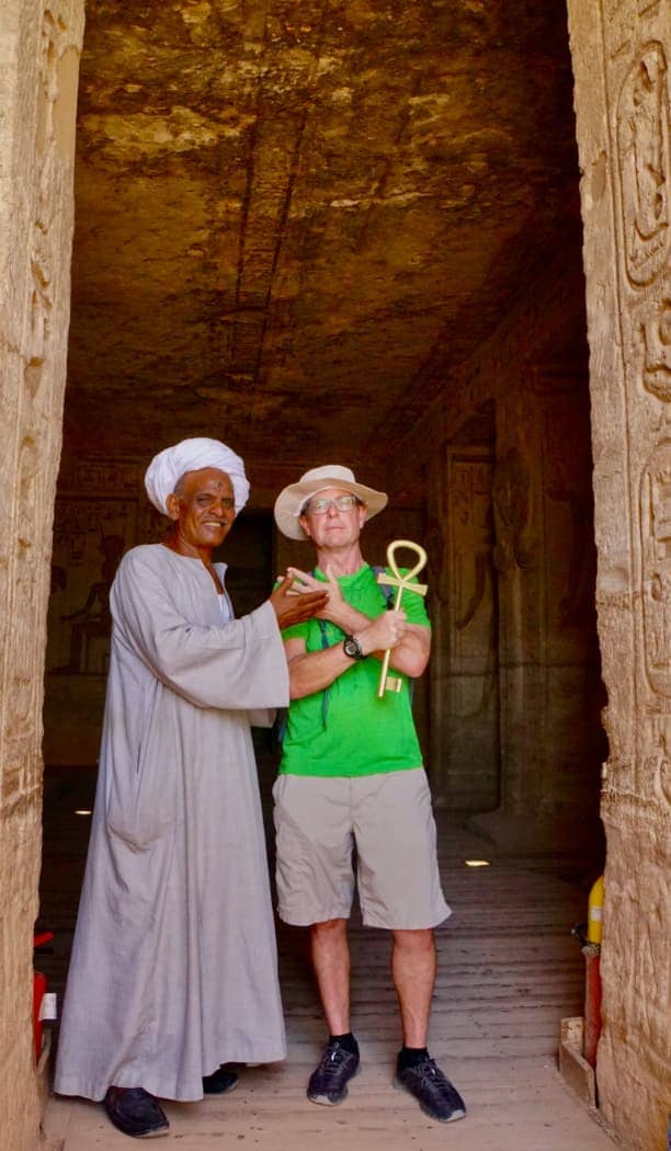 Man posing with artifact and local man