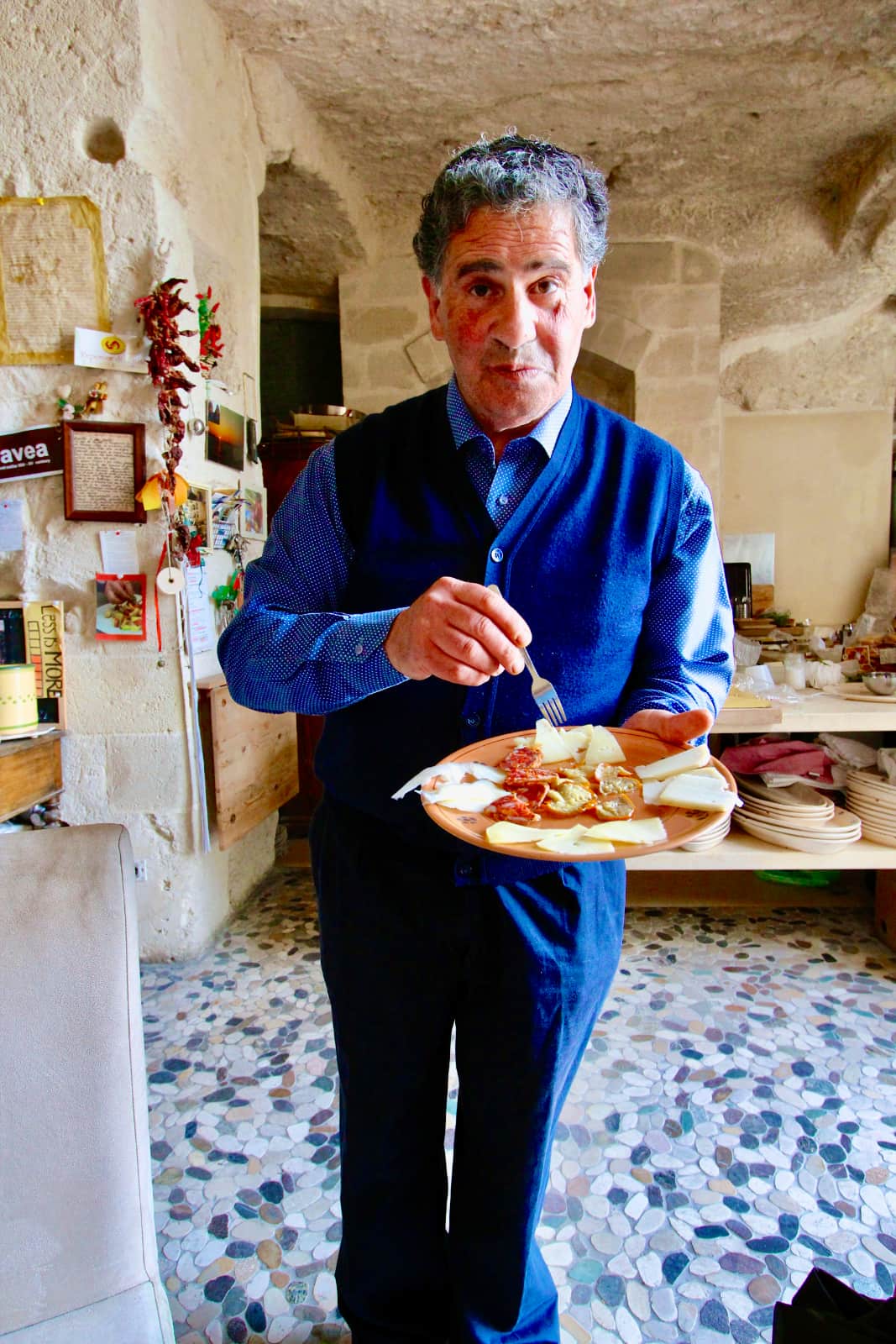 Man serving meat and cheese plate