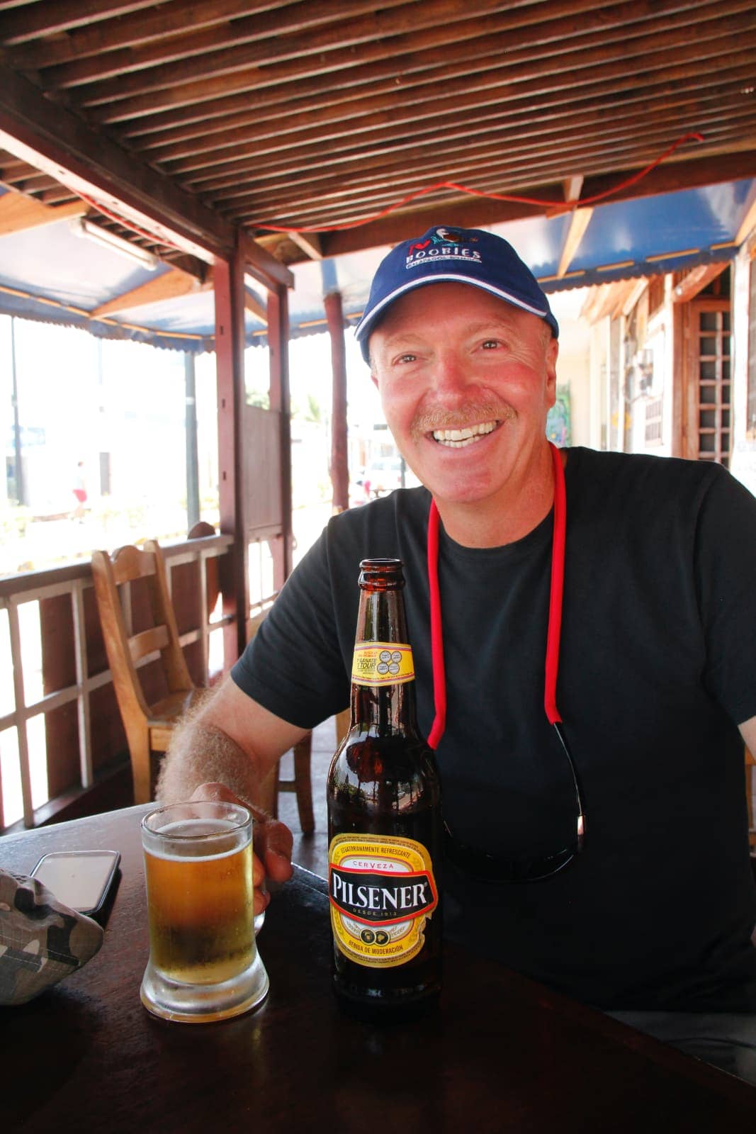 Man smiling while enjoying beer