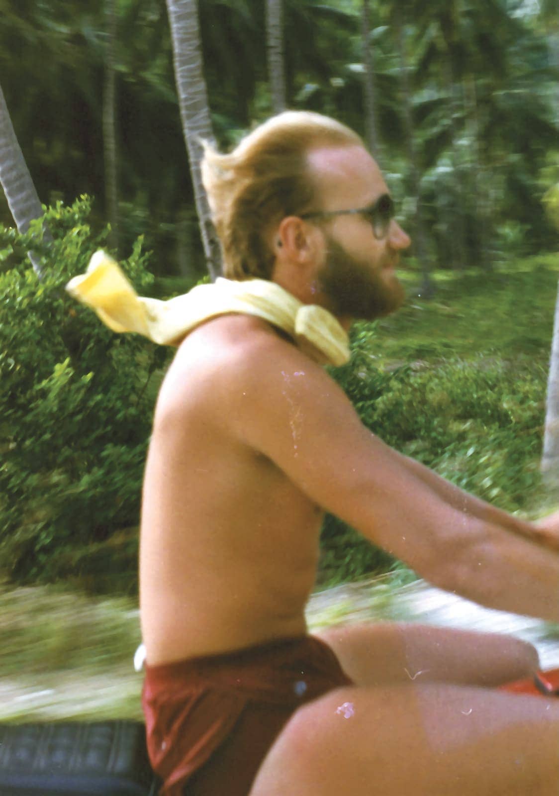 Man with beard riding motorcycle