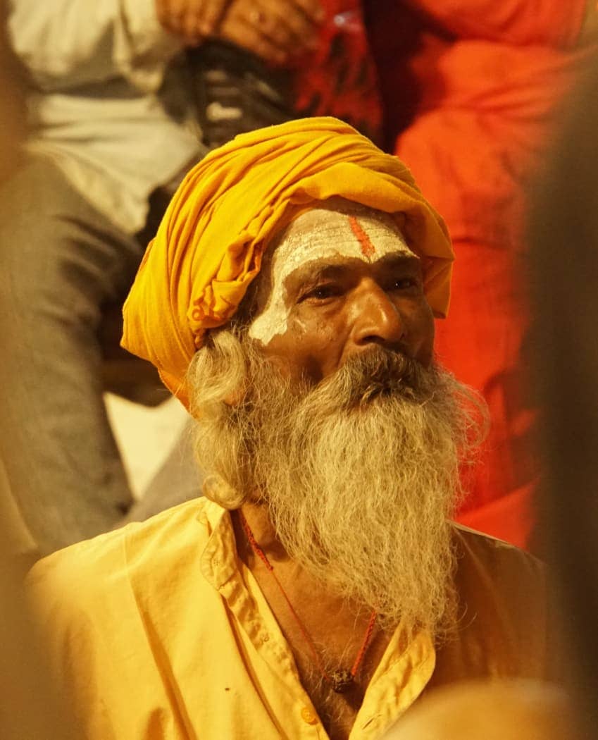 Old man with beard dressed in yellow clothes