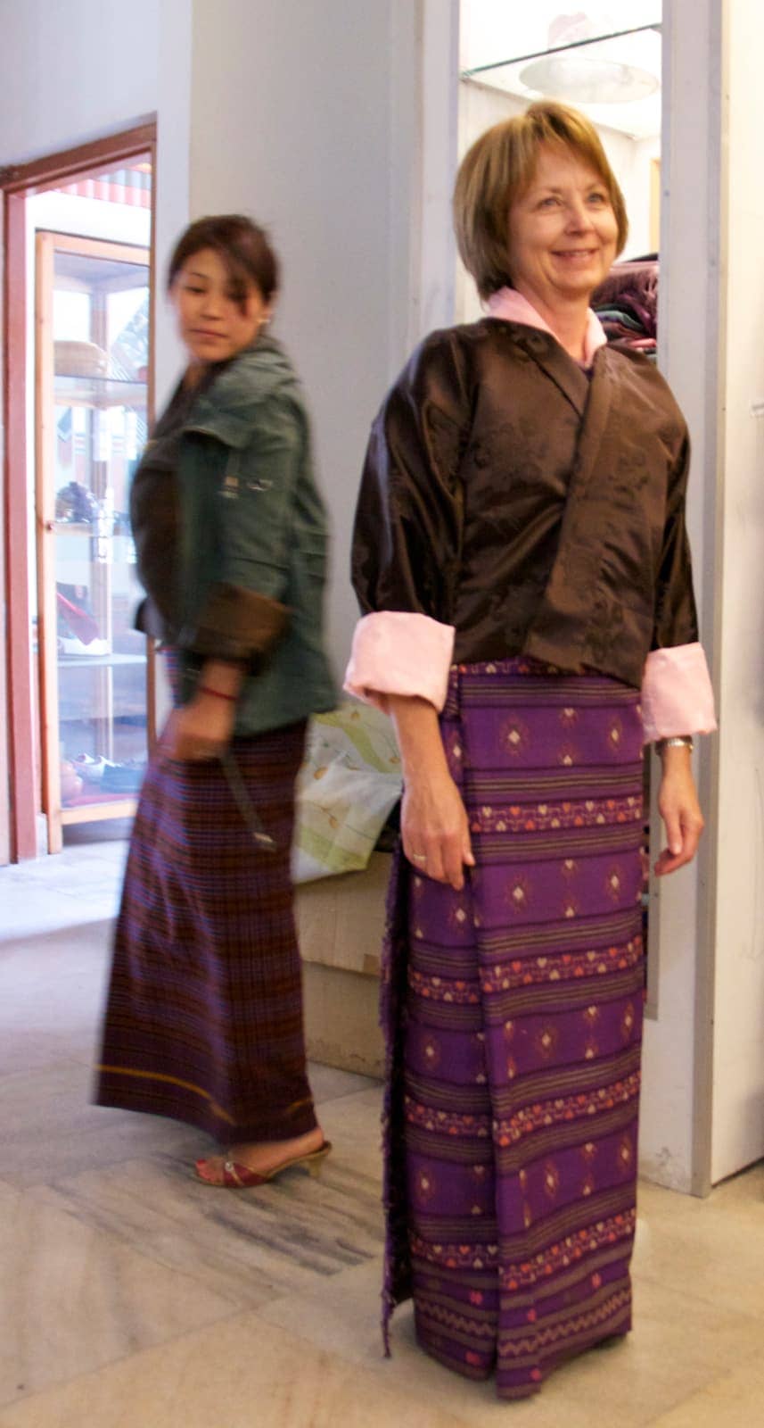 One woman admiring another in Bhutanese clothing