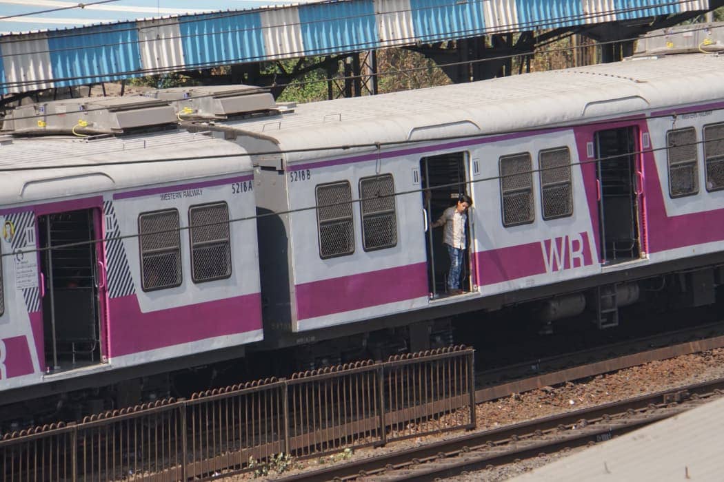 Person riding purple and grey train