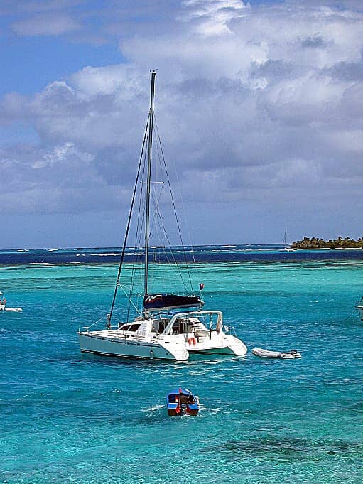 Sailing catamaran on turquoise ocean water