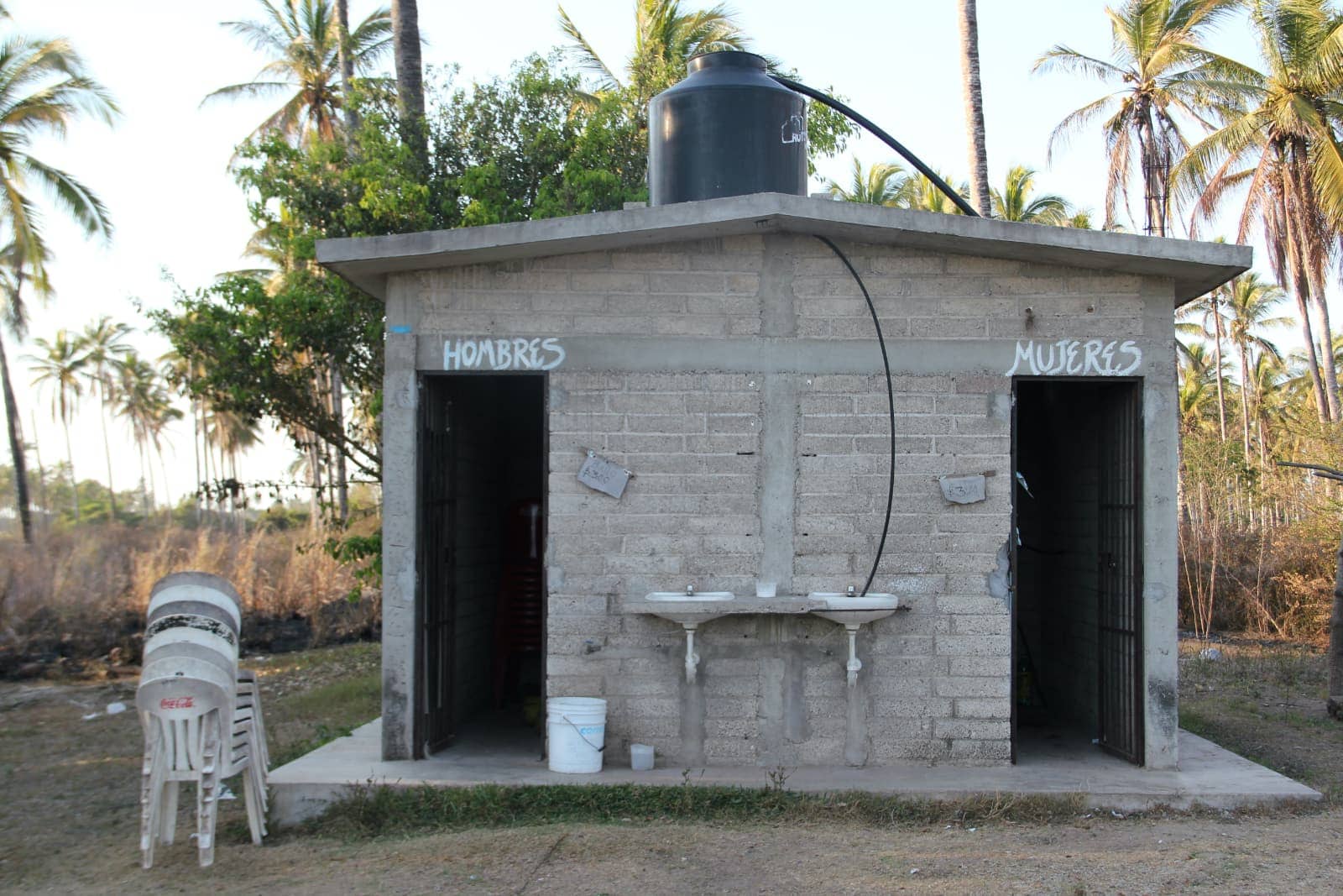 Stone mens and womens outdoor toilets