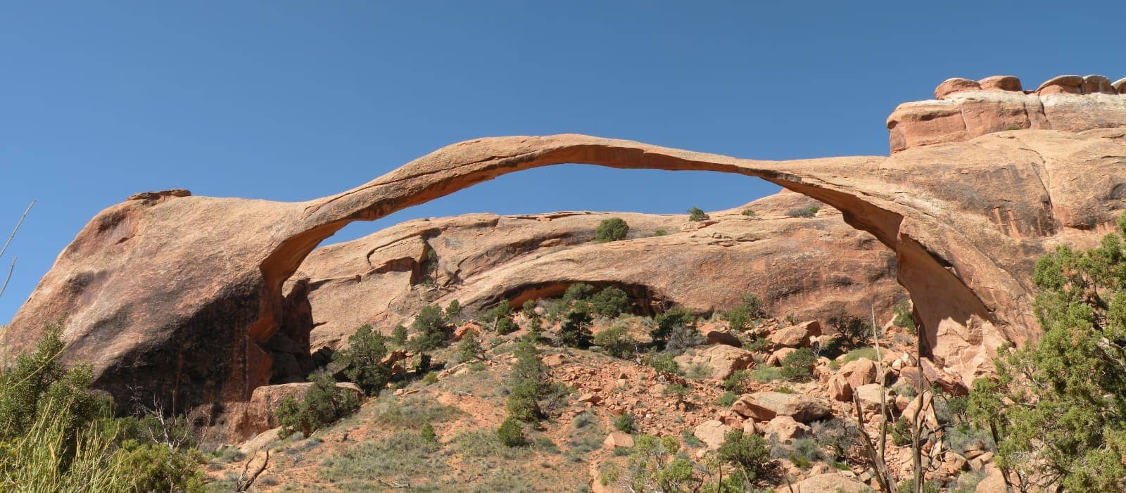 Thin rock arch with blue sky in background