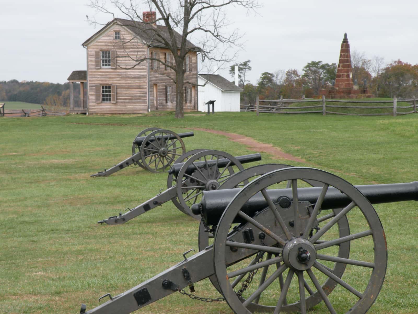 Three old cannons in foreground with buildings in background