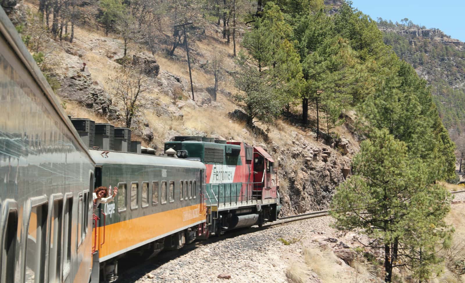 Train moving along tracks through desert hills