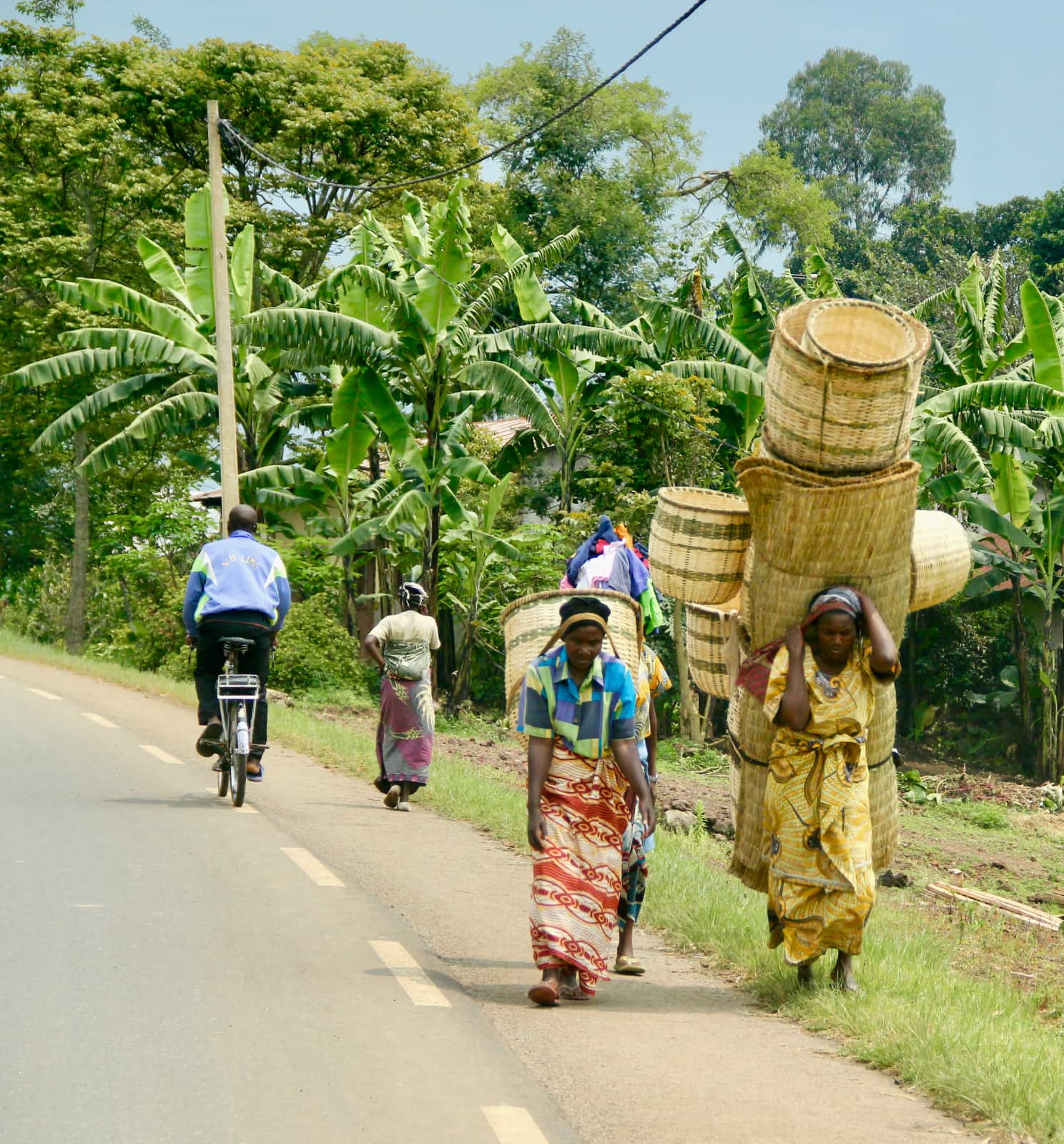 Two African women carrying hand woven textiles