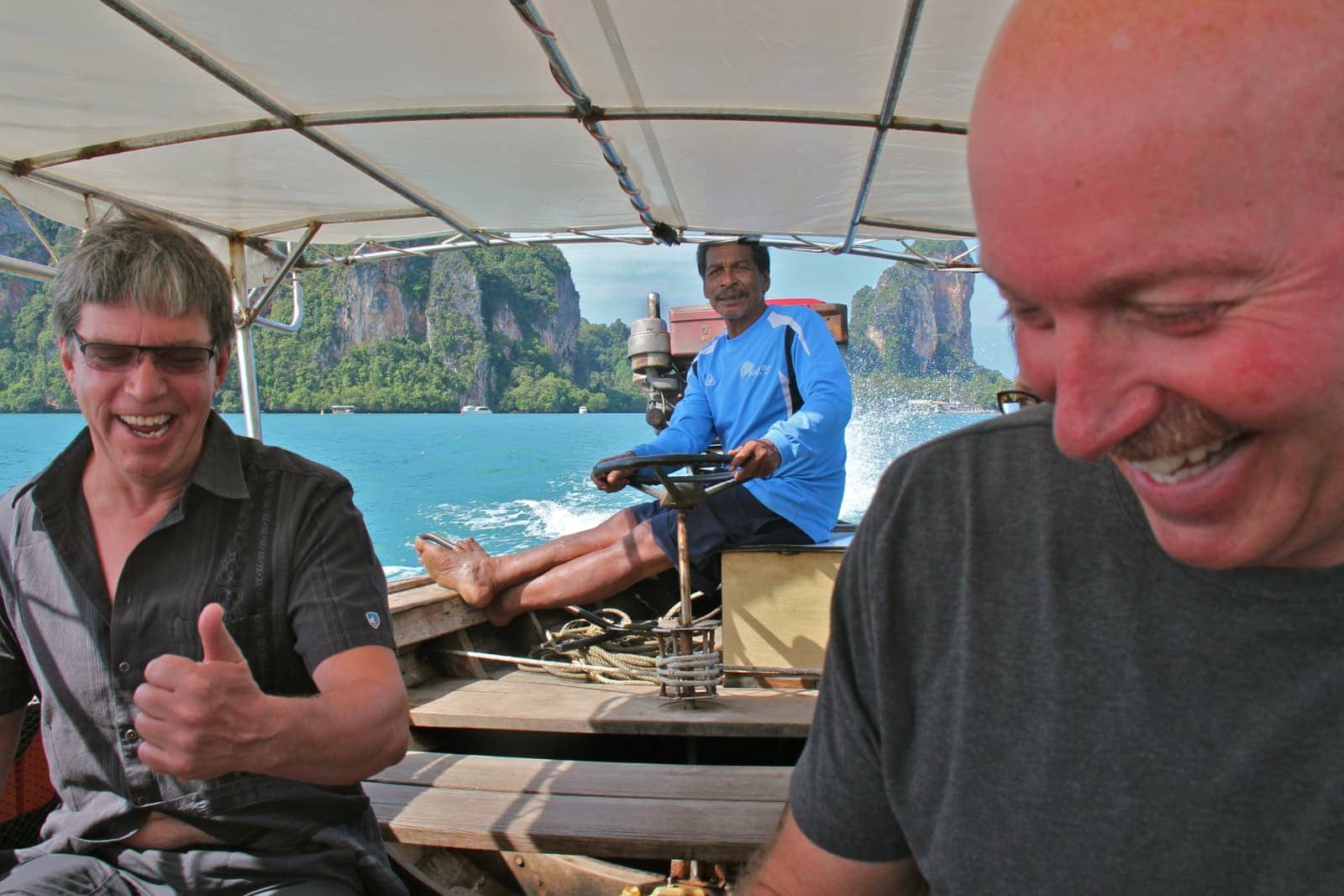 Two men riding on Thai long boat