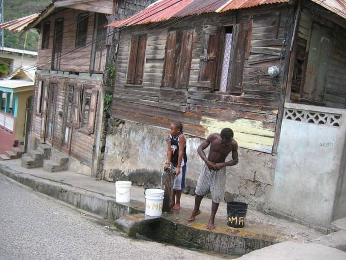 Two men standing with buckets