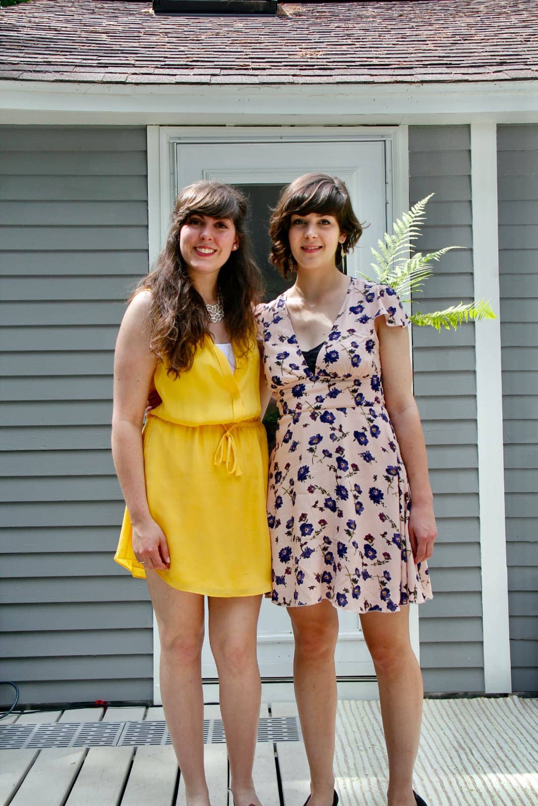 Two women in dresses posing for camera