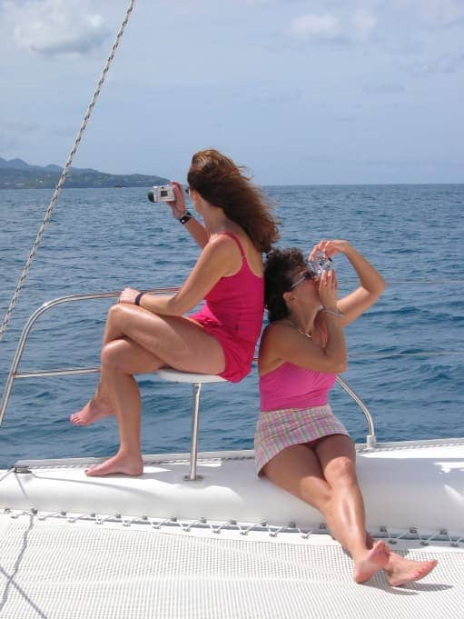 Two women in pink swimsuits taking photos