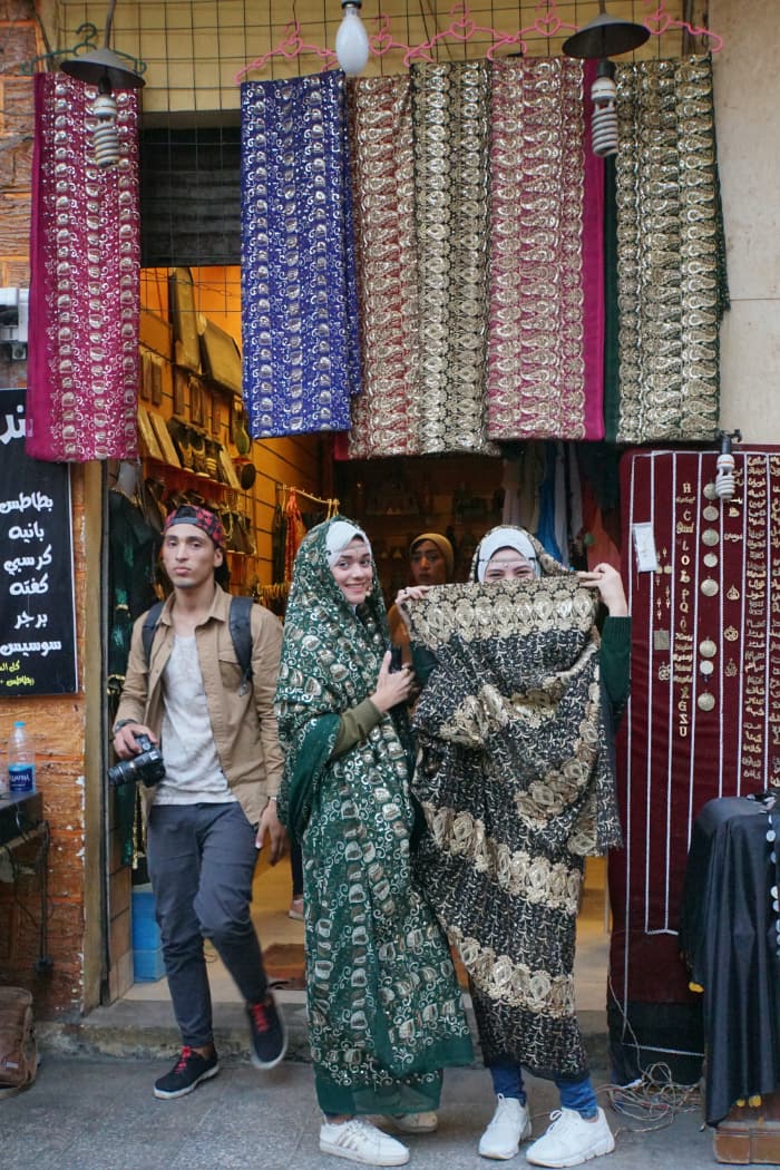 Two women posing outside textile store in Cairo