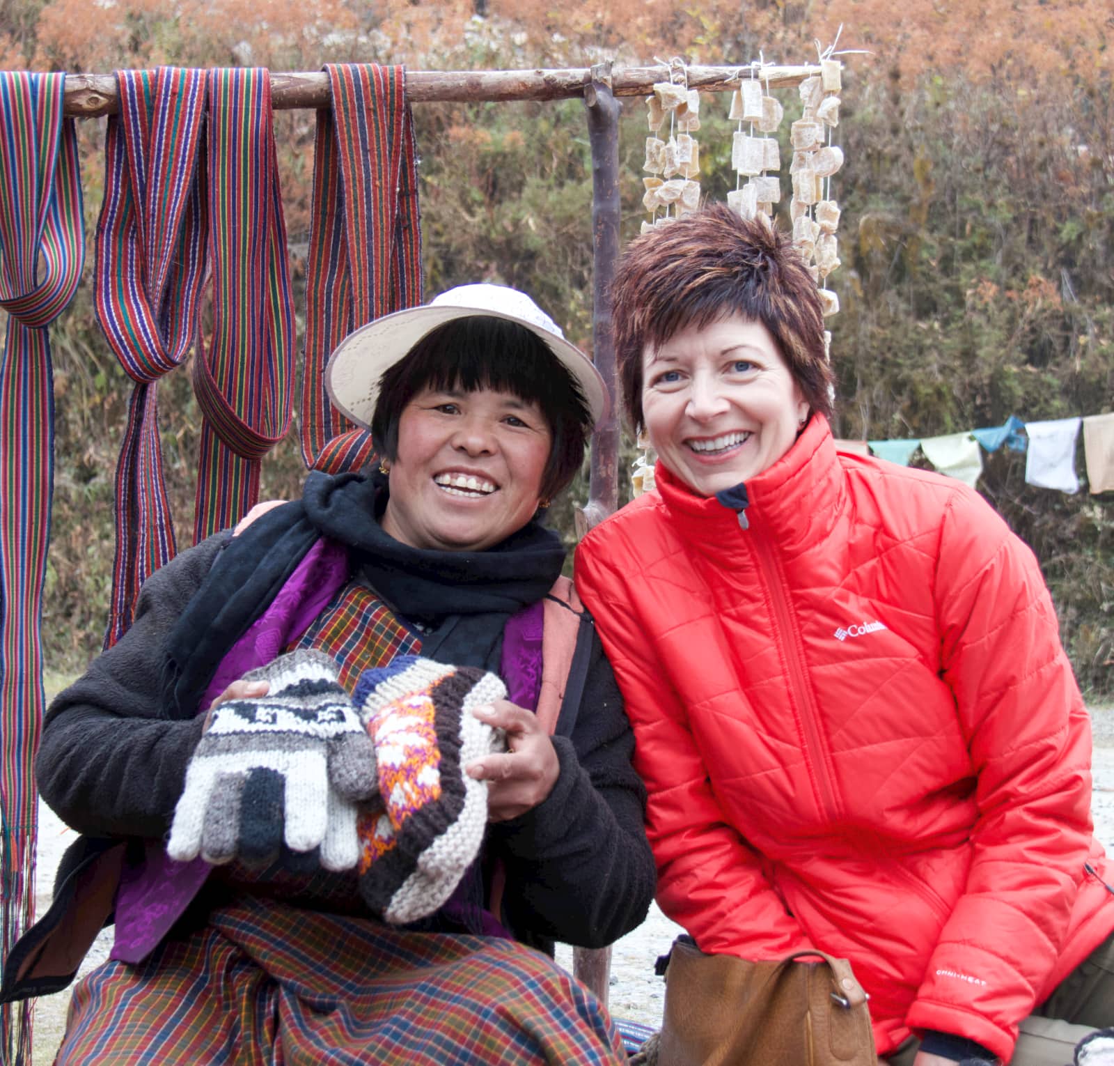 Two women sitting and smiling at camera