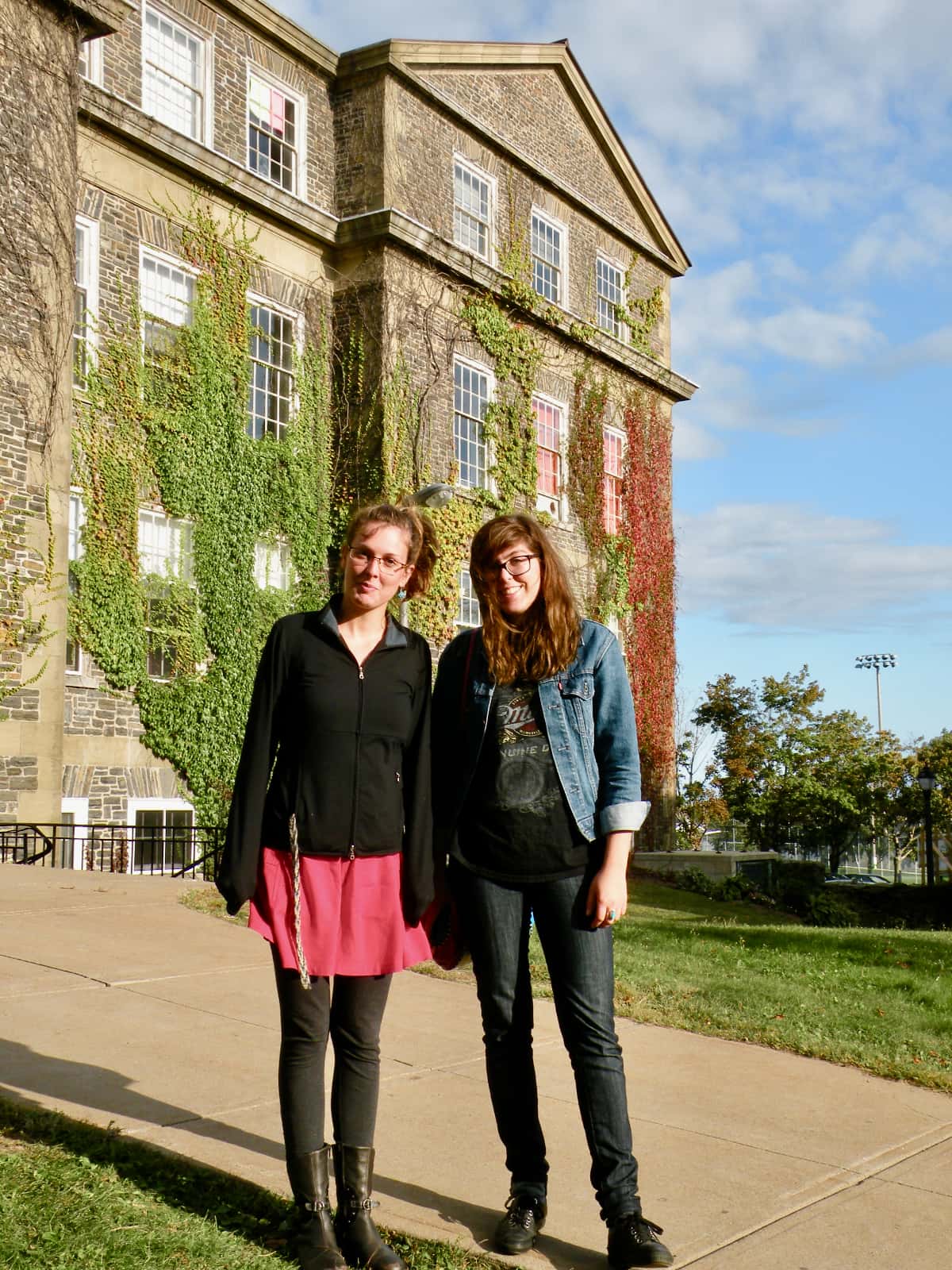 Two women standing in front of old stone building