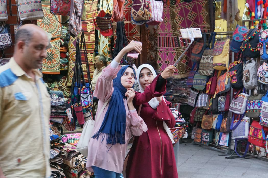 Two women taking a selfie in market