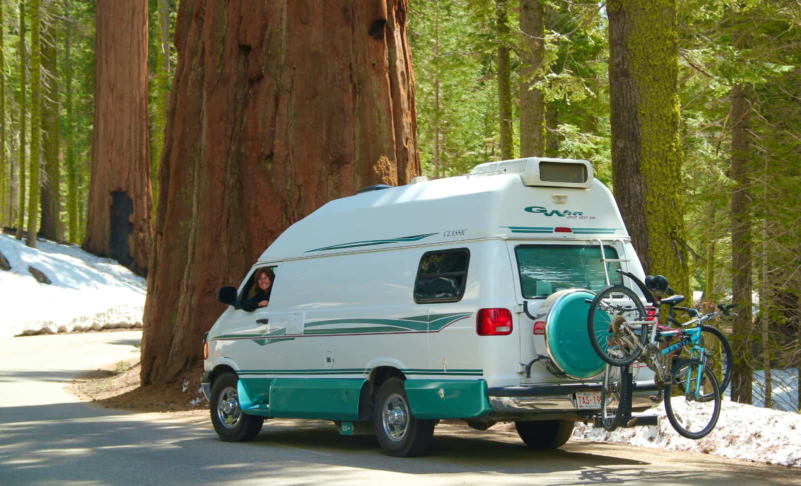 White and turquoise camper van parked on road