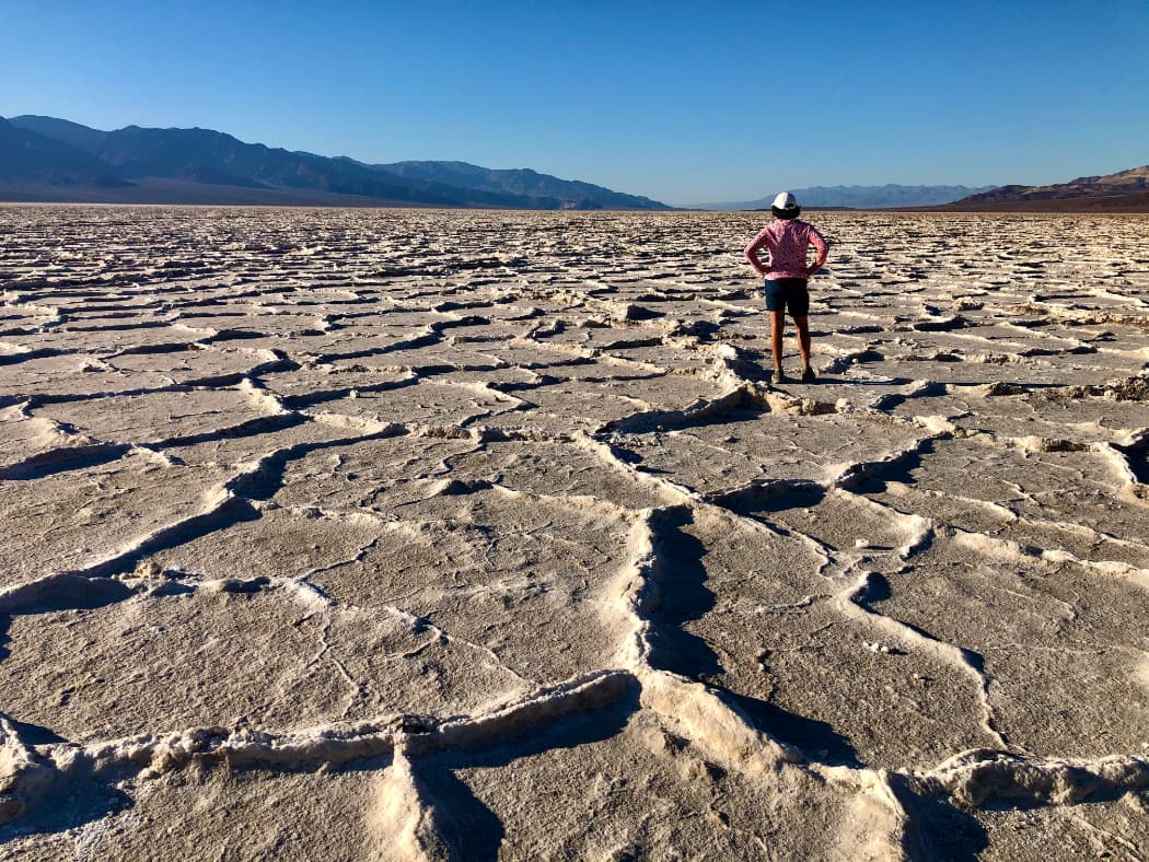 Woman admiring view of salt flats and mountains