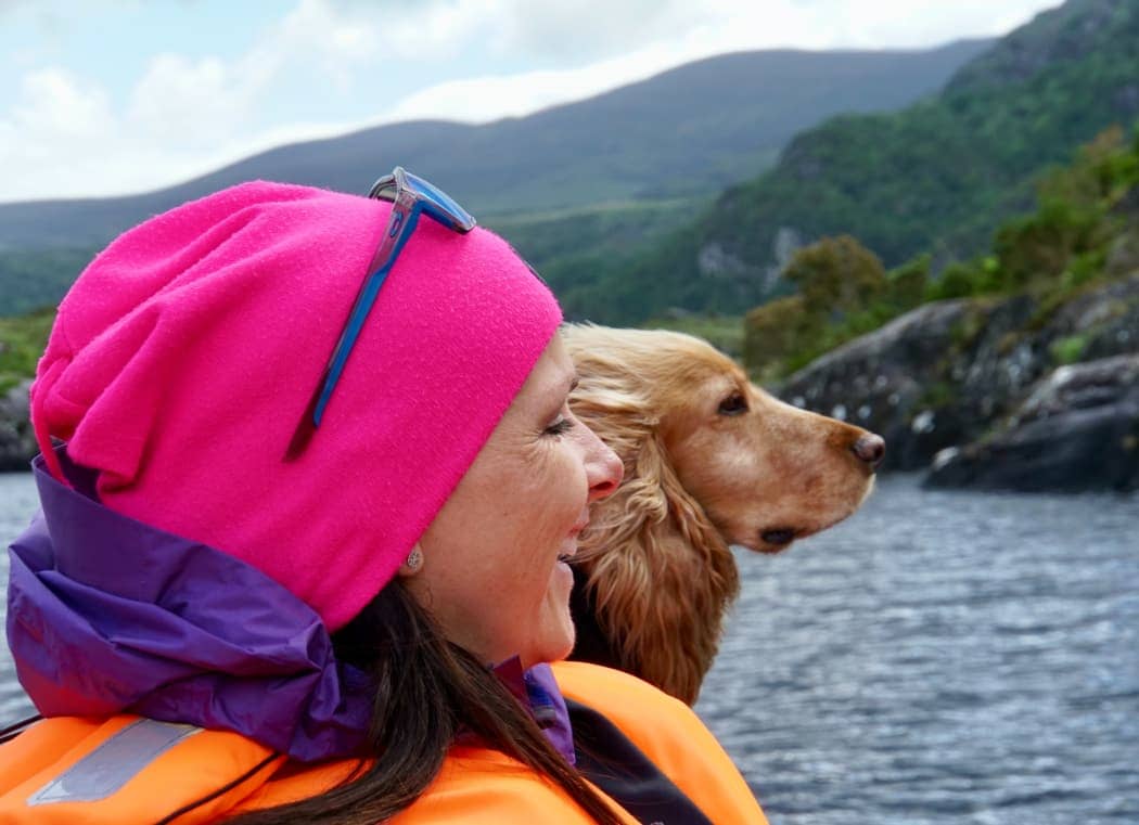 Woman and dog enjoying view from boat