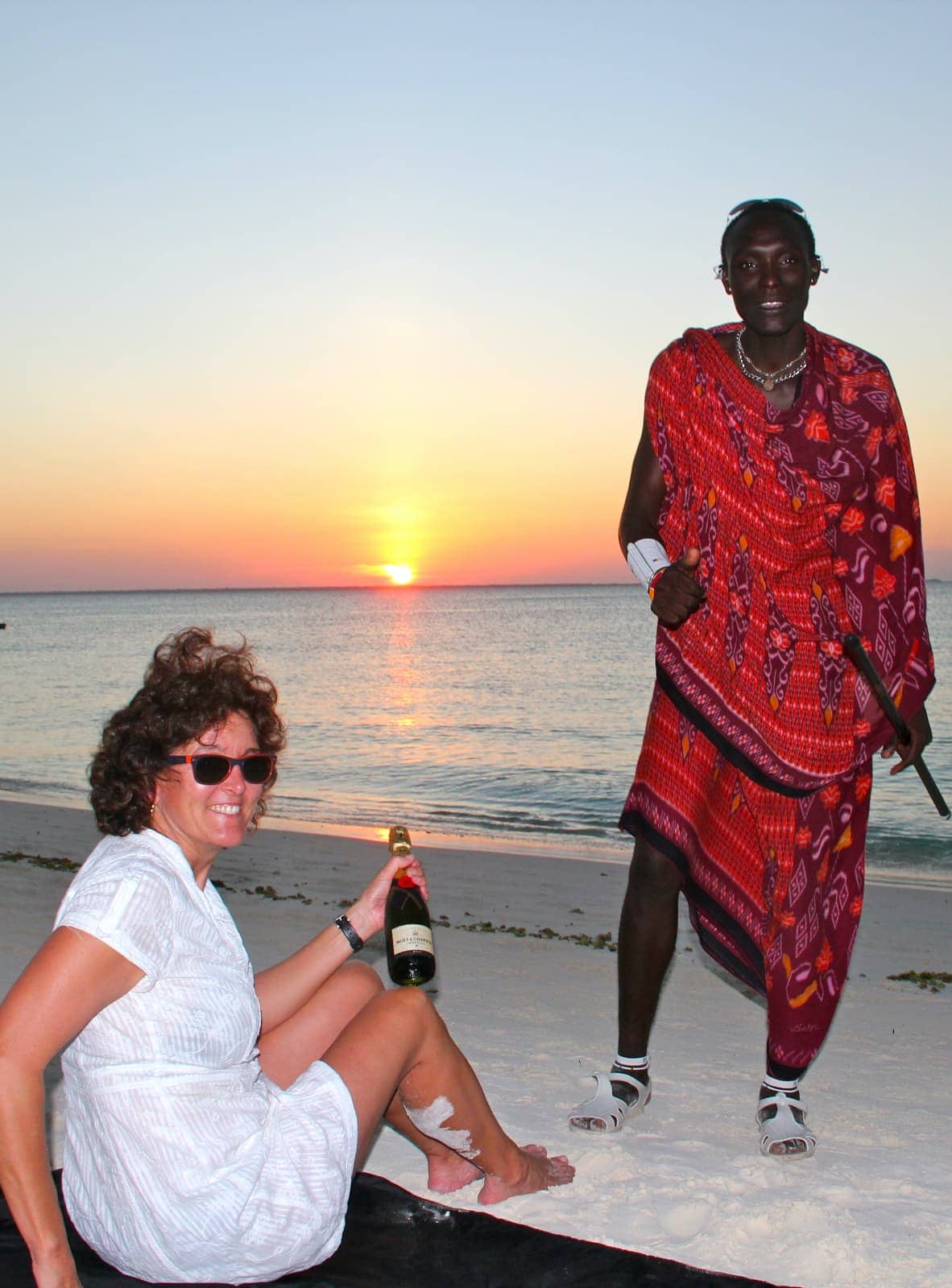 Woman and man interacting on beach at sunset