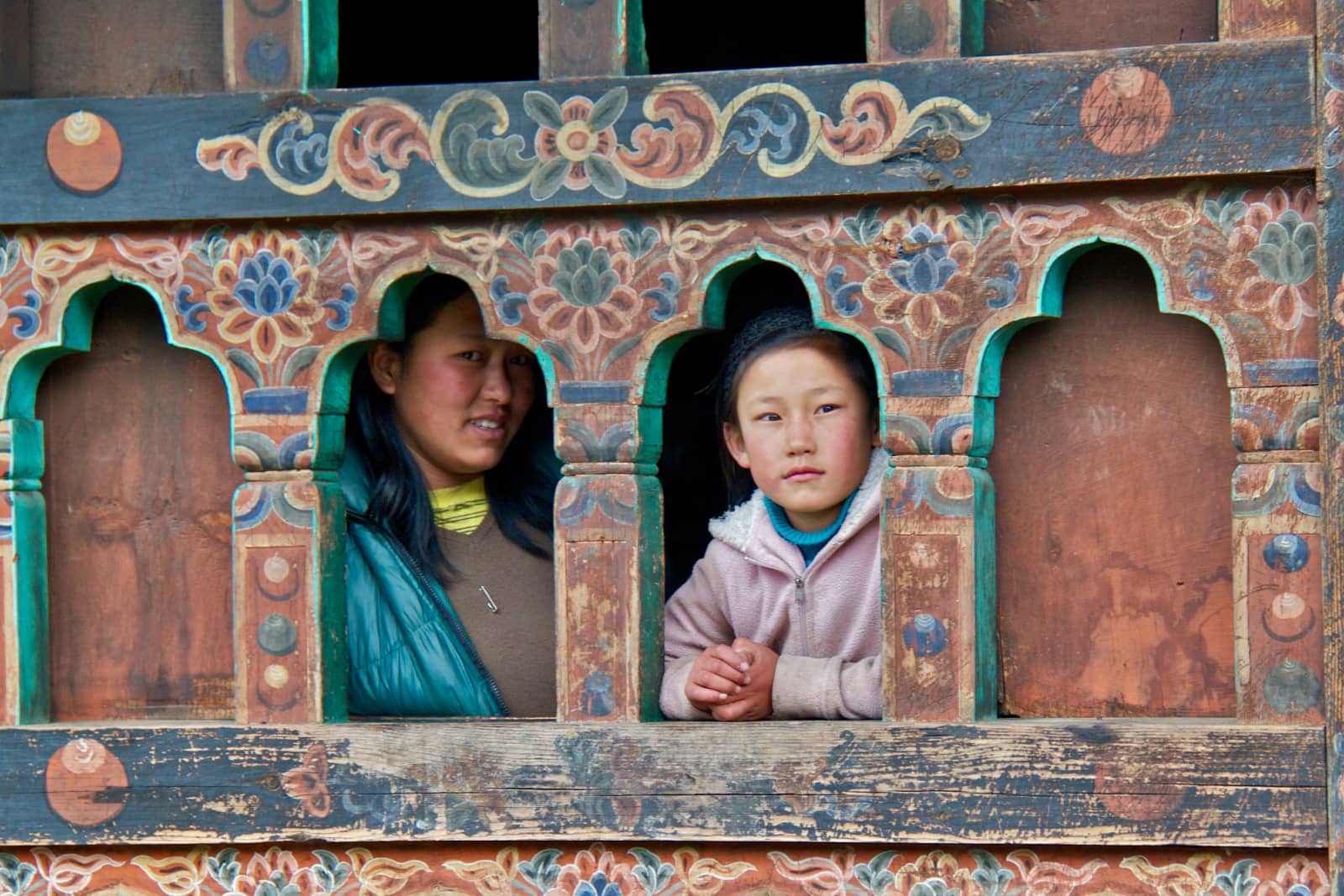 Woman and young child standing in windows