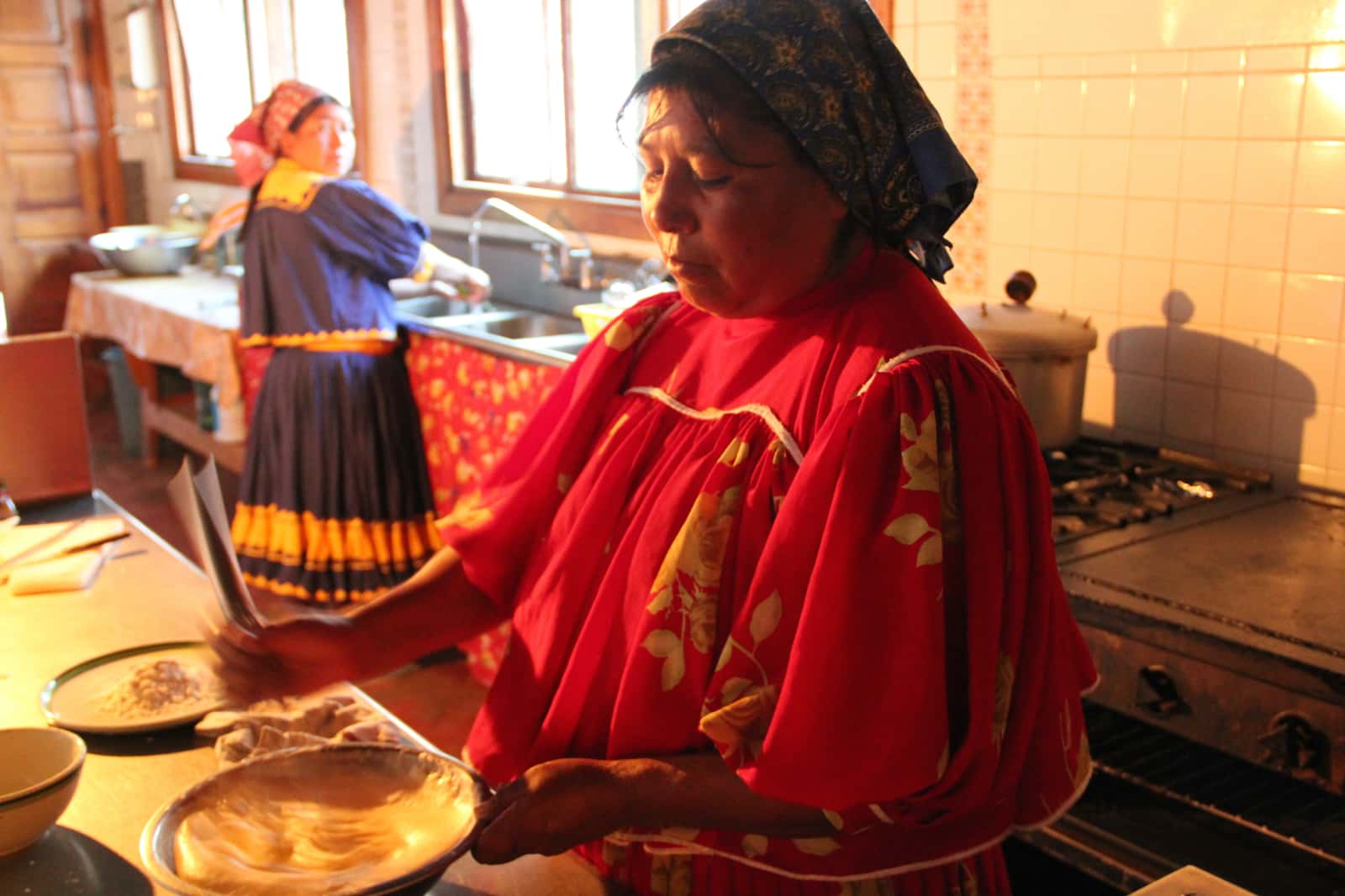 Woman cooking local food in kitchen