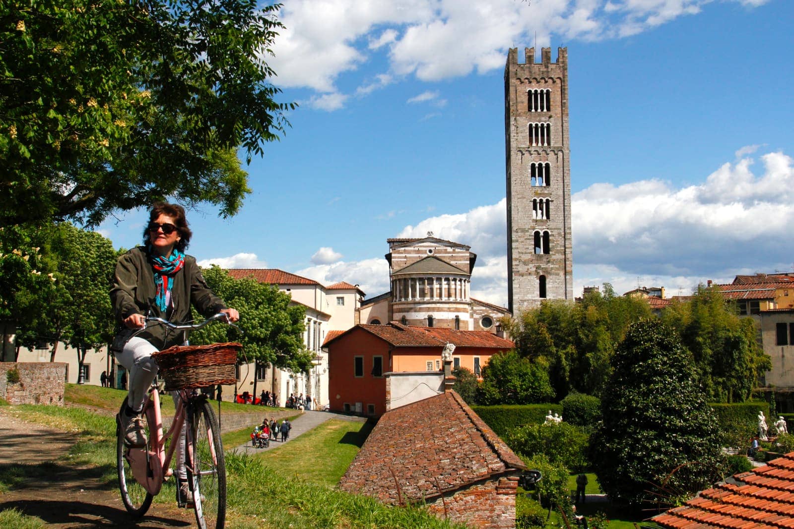 Woman cycling through old village