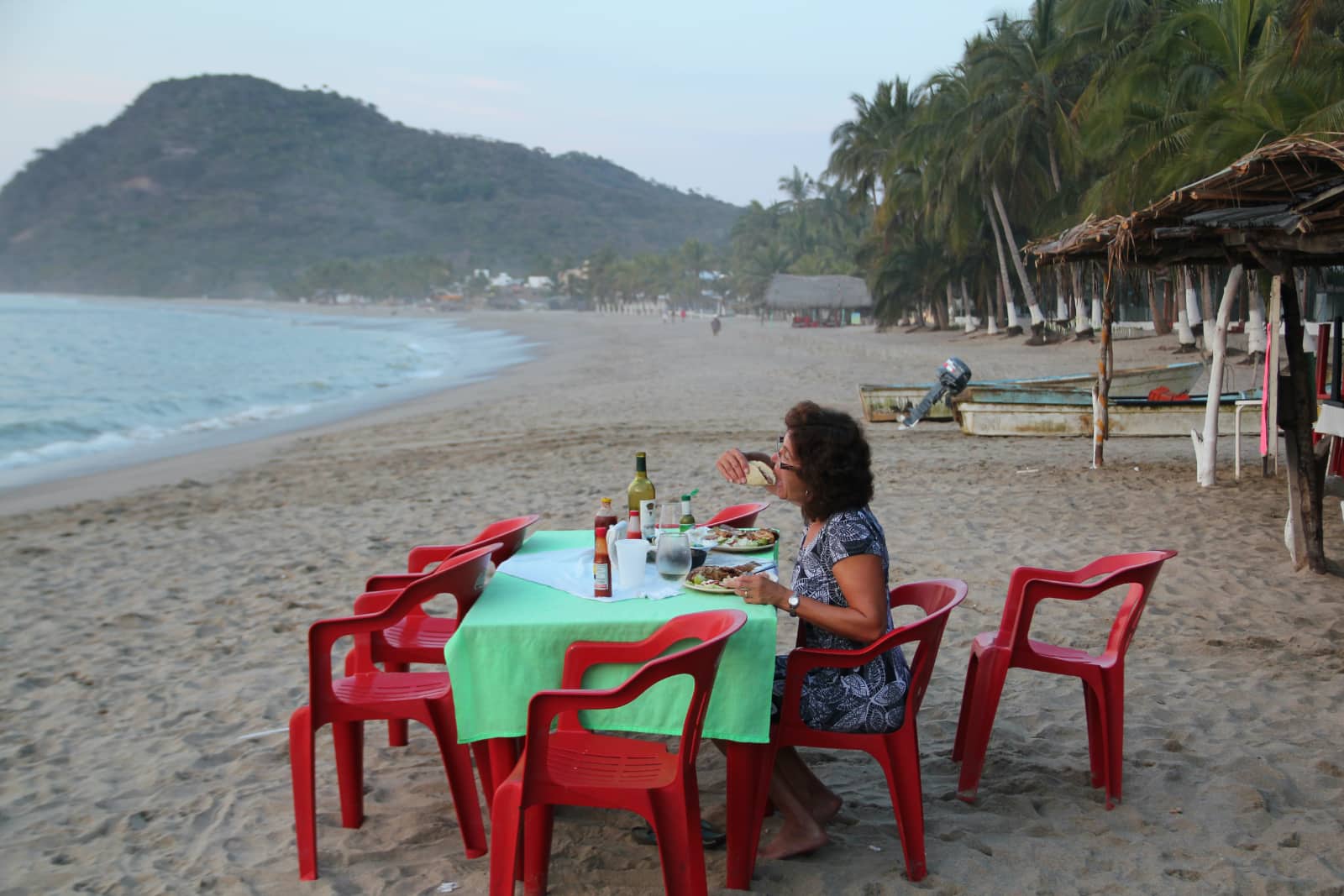 Woman enjoying meal on beach