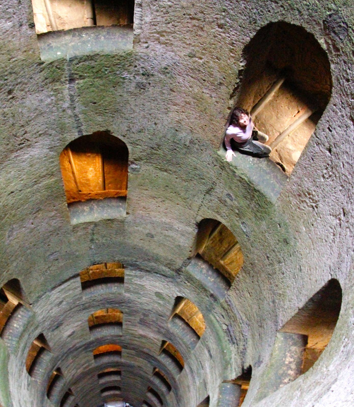 Woman looking up through tower