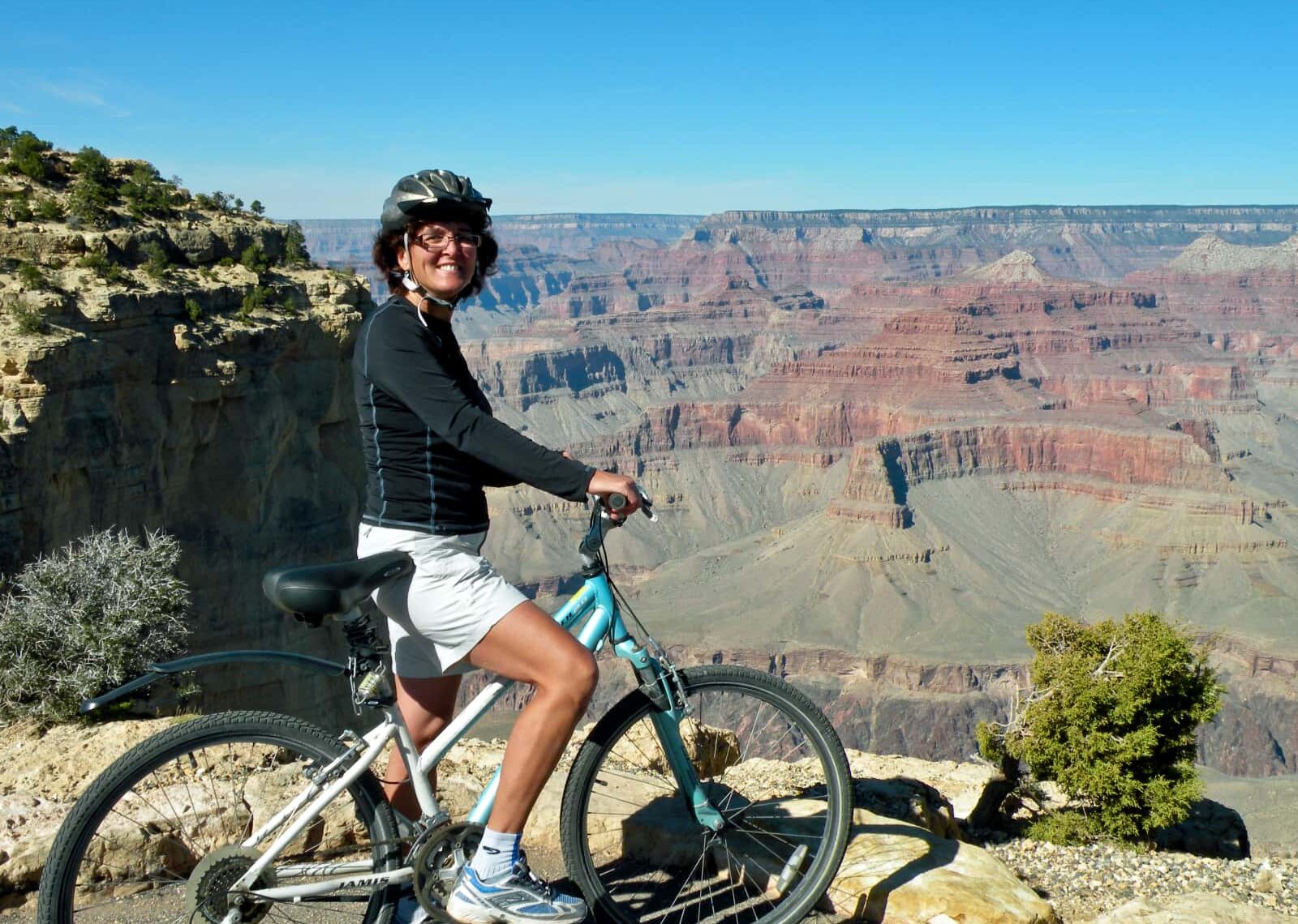 Woman on bike over looking canyon