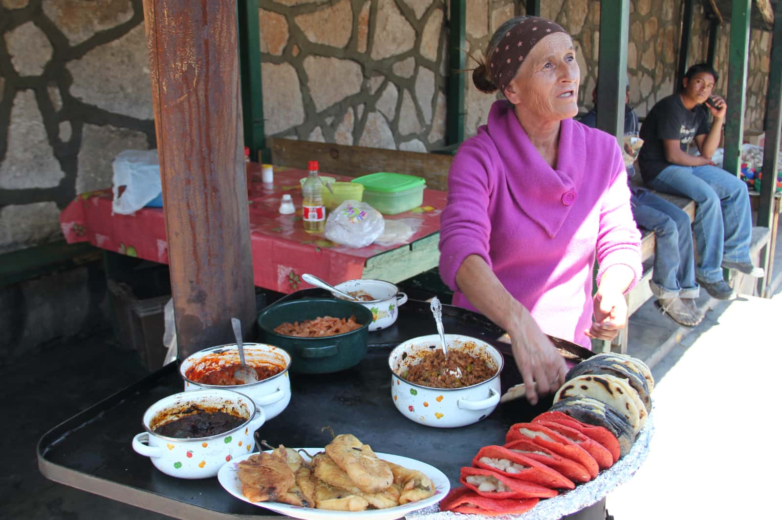 Woman selling local food at stall