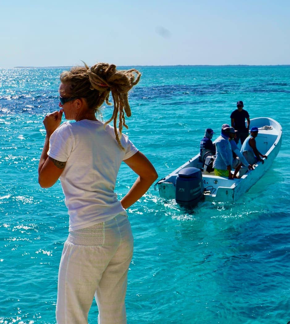 Woman standing in front of departing boat