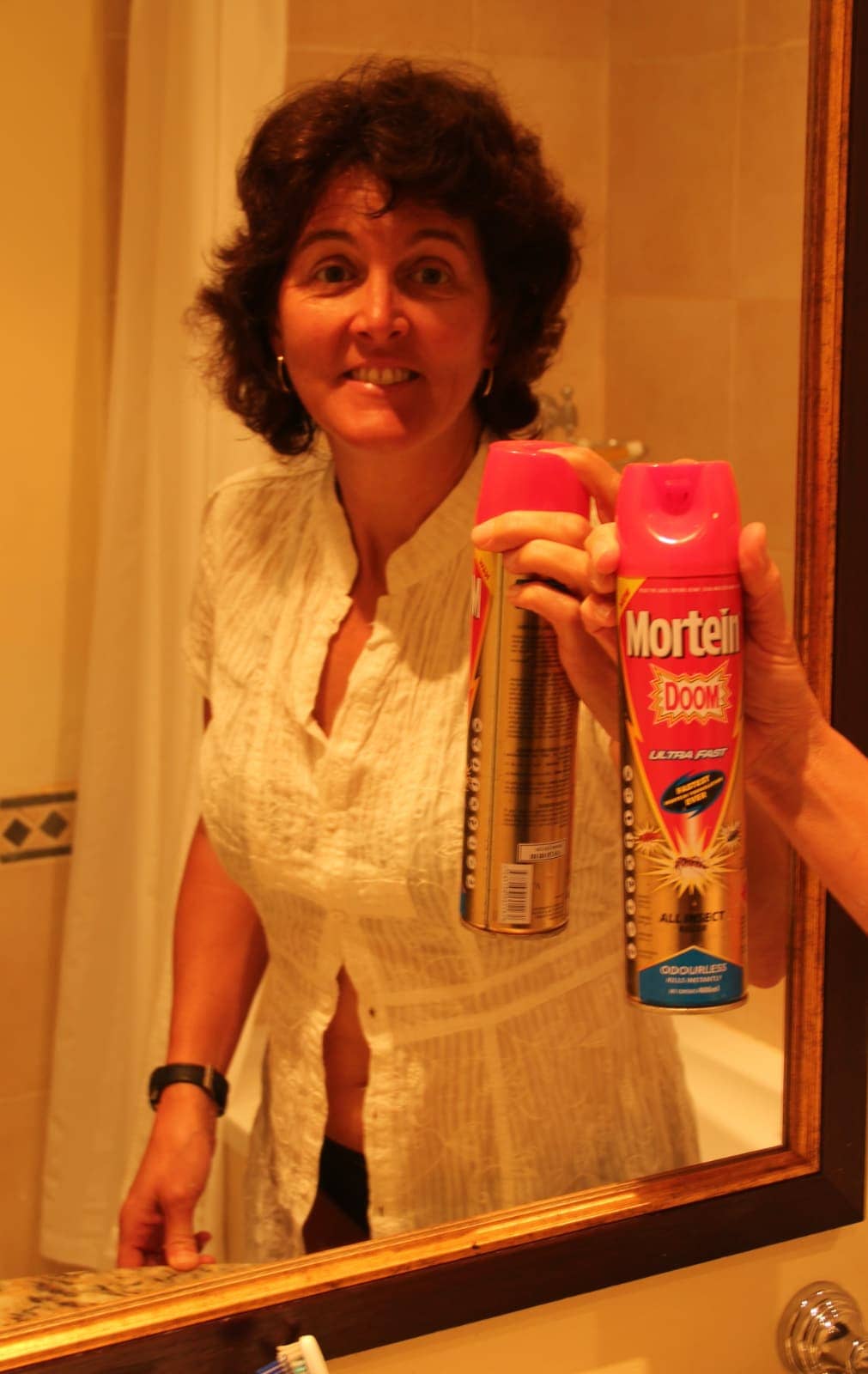 Woman standing with Mortein insect repellent canister in hand