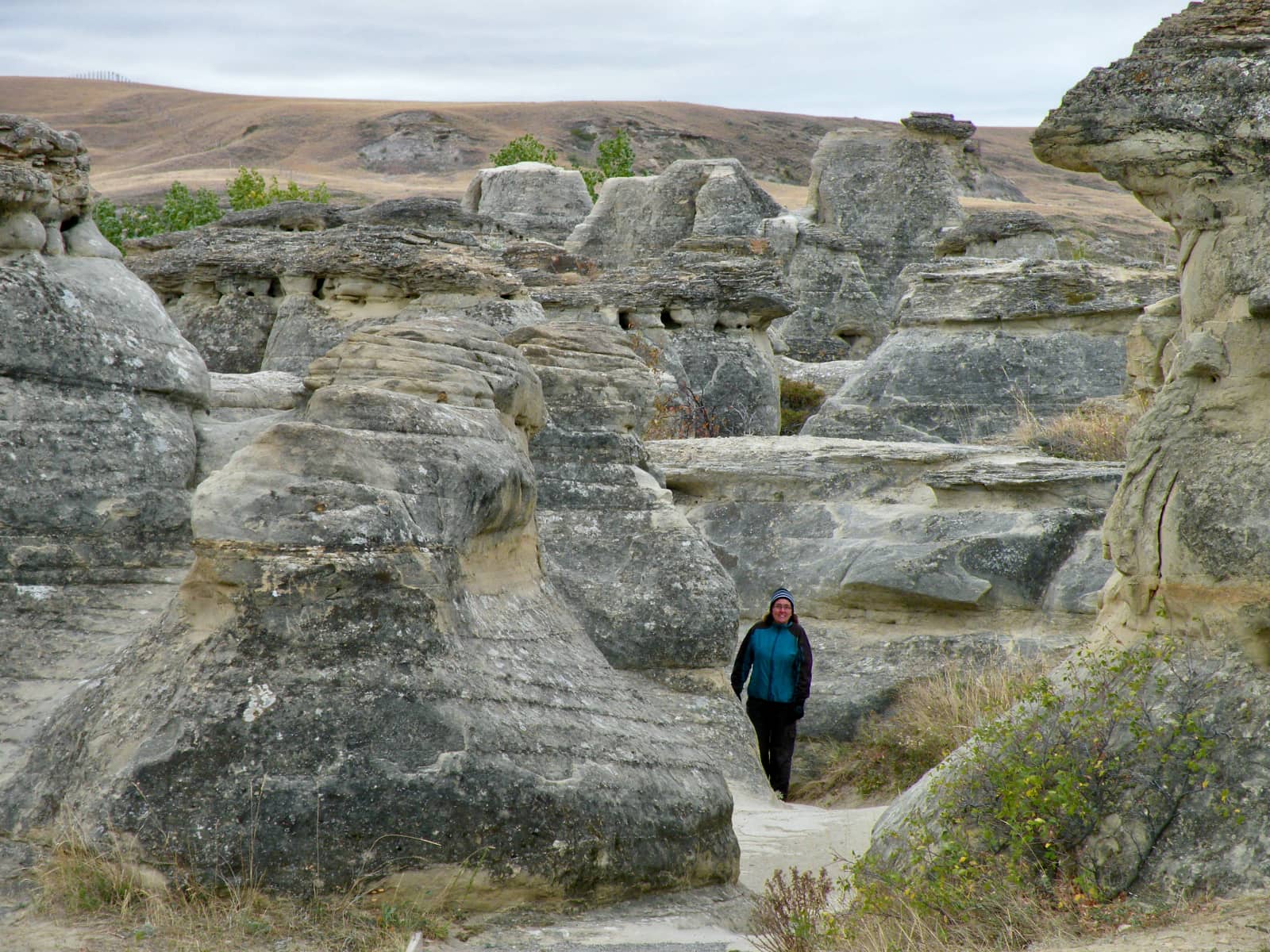 Woman walking through unique rock formations