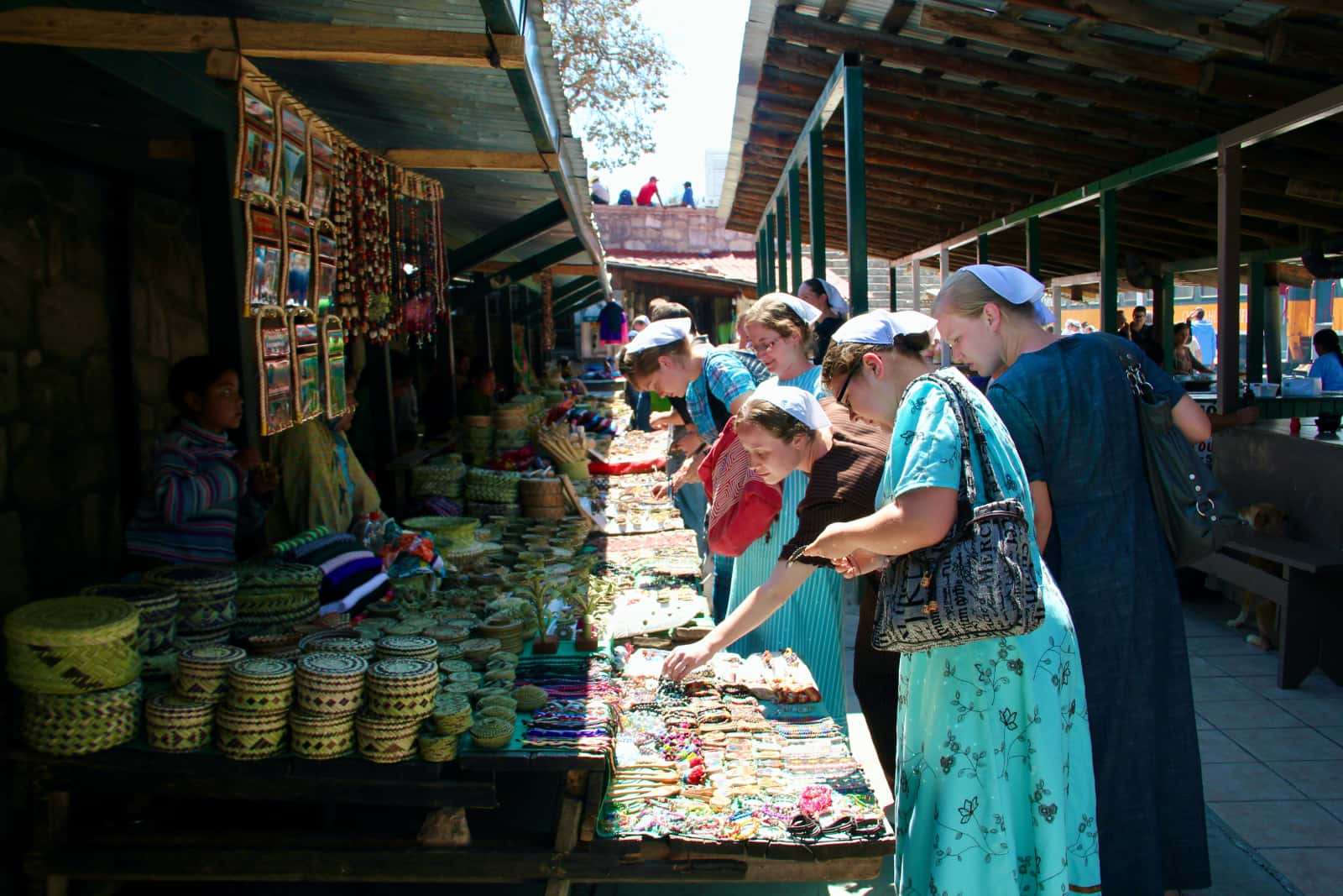 Women in long dresses viewing local artisan products