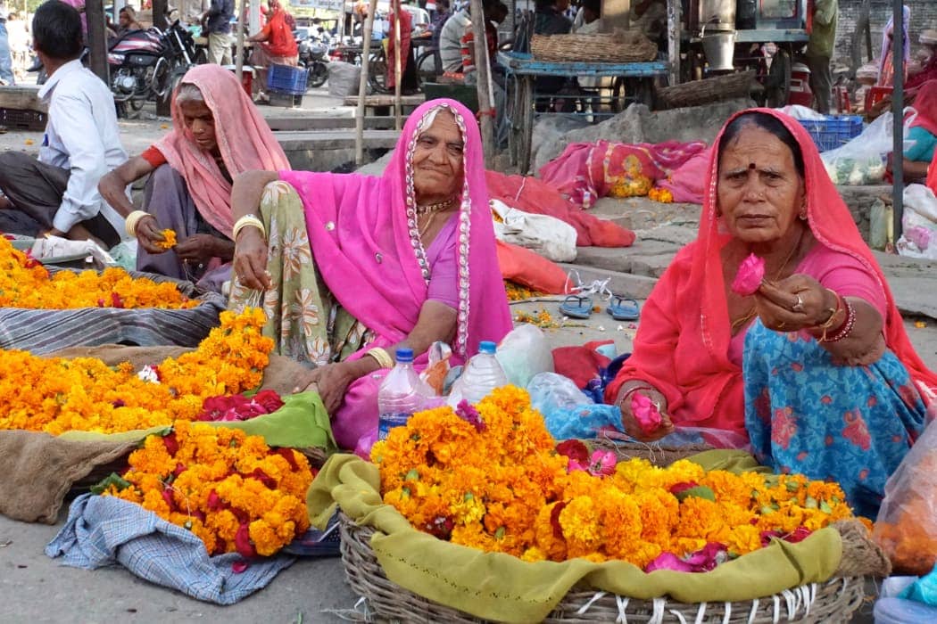 Women selling flowers on roadside