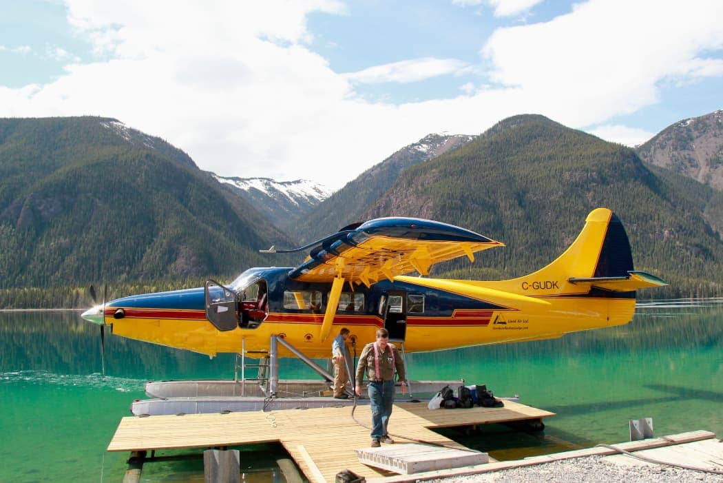 Yellow and blue float plane with passengers