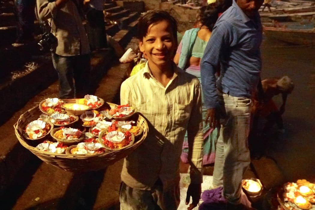 Young boy selling ceremonial candles