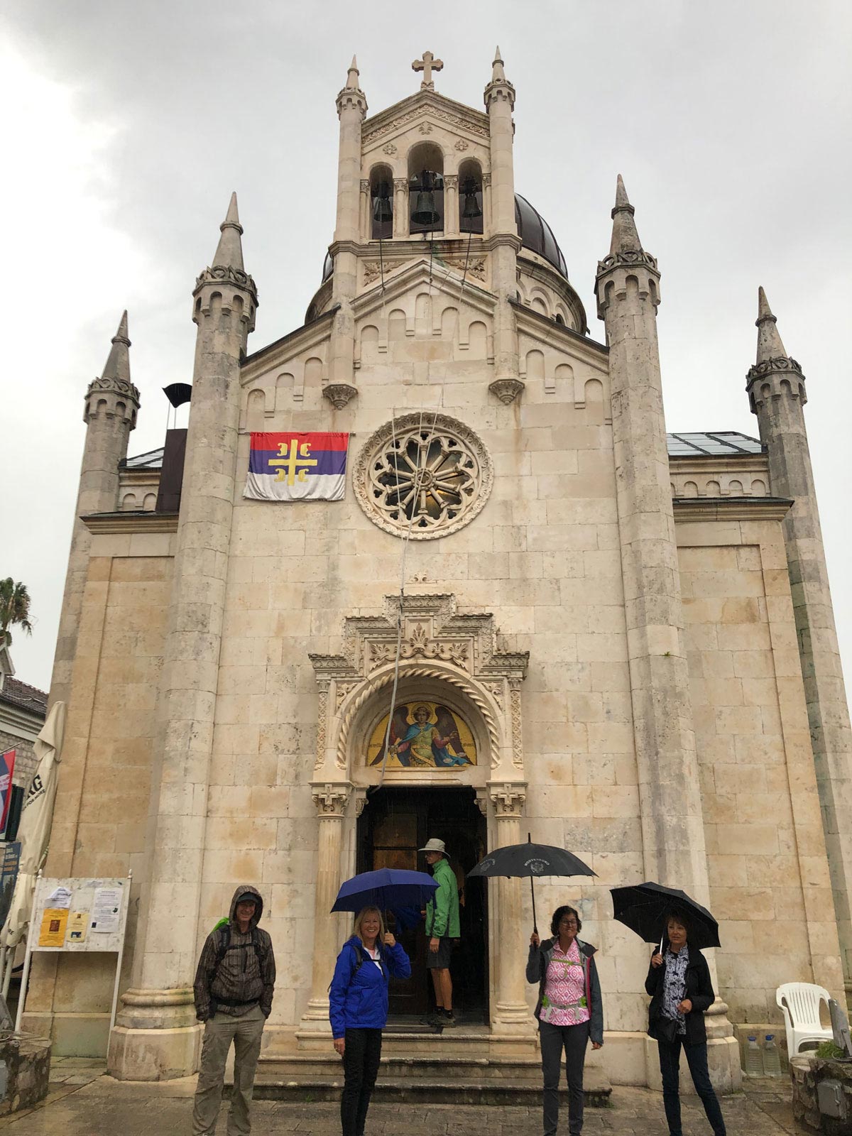 People with umbrellas outside church