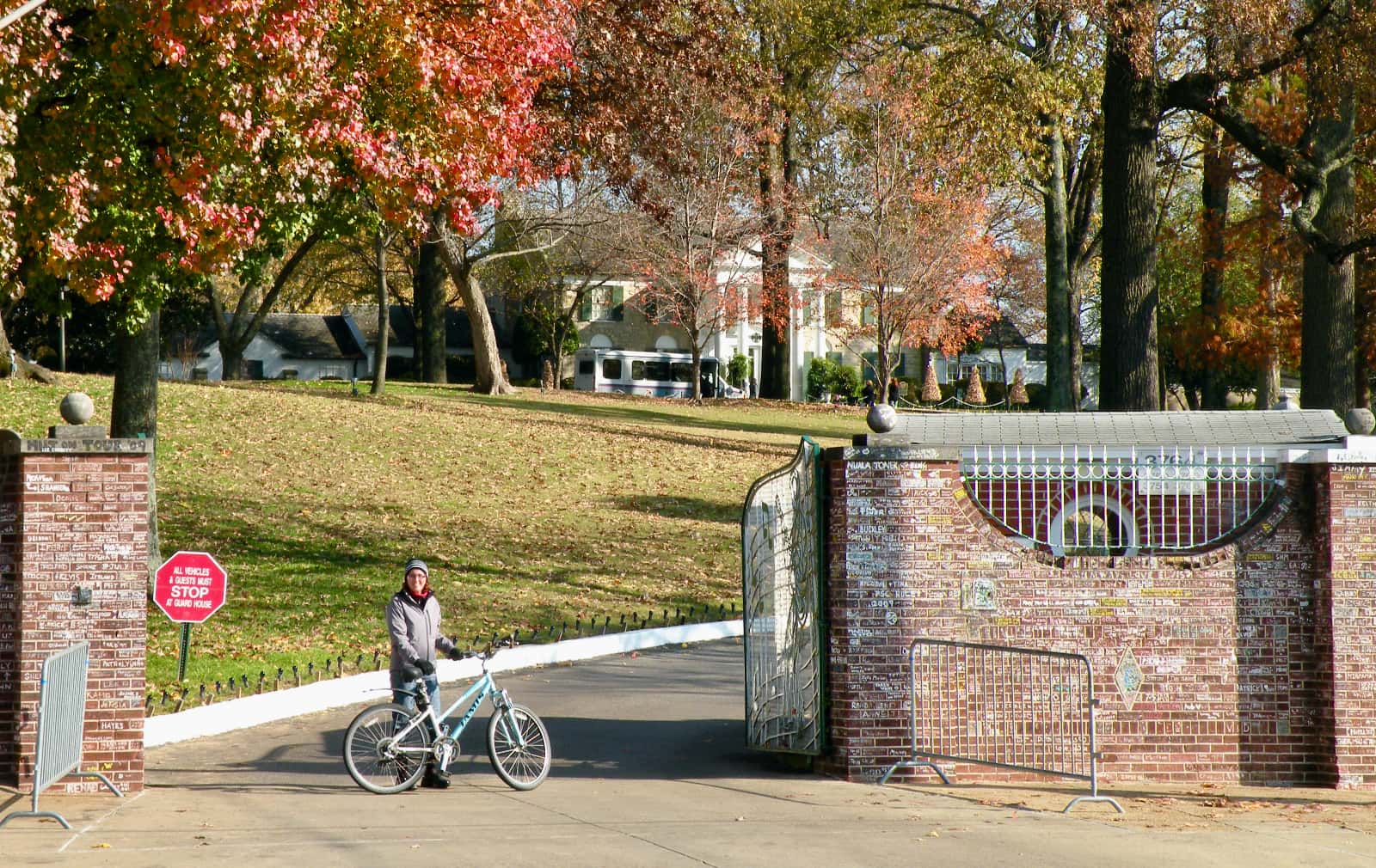 Woman standing with bicycle outside Graceland compound